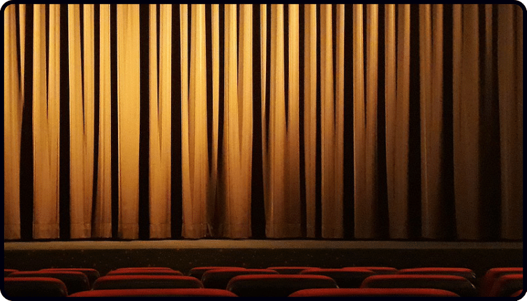 Red theatre curtains symbolizing the immersive nature of audio storytelling as a standalone medium.