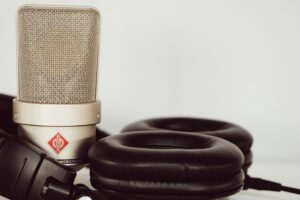 Close up of podcast mic and headphones, used on blog about cultivating brand loyalty and brand fandom