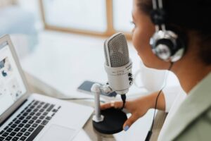 Close up shot of person speaking into microphone, used on blog about healthcare industry podcasts