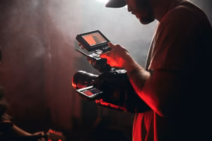 Camera operator filming a creator-led video podcast in a professional studio.