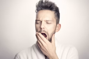 Photo of a guy yawning, illustrating the idea of a boring industry podcast.