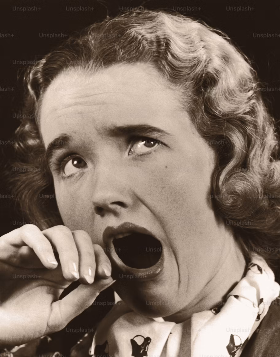 Vintage black-and-white photo of a woman yawning, illustrating the idea of a boring industry podcast.