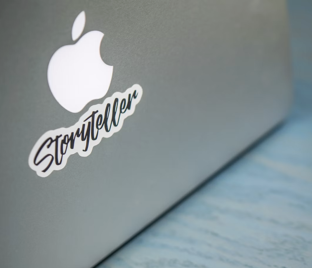 Storyteller sticker on an Apple MacBook illustrating brand storytelling in the age of AI