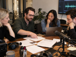 Podcast producer and company team reviewing an episode outline together.